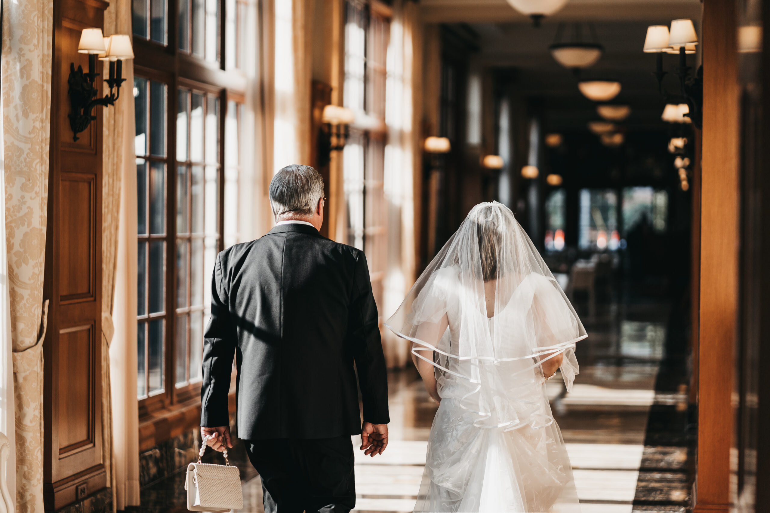 Bride and Groom walking down the hallway before their intimate Michigan Wedding.