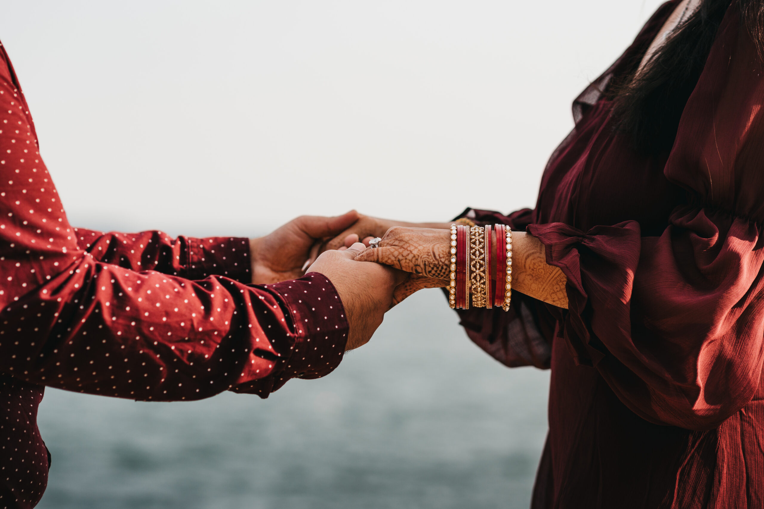 Close up of mehndi details on bride’s hands during adventure session in Acadia National Park