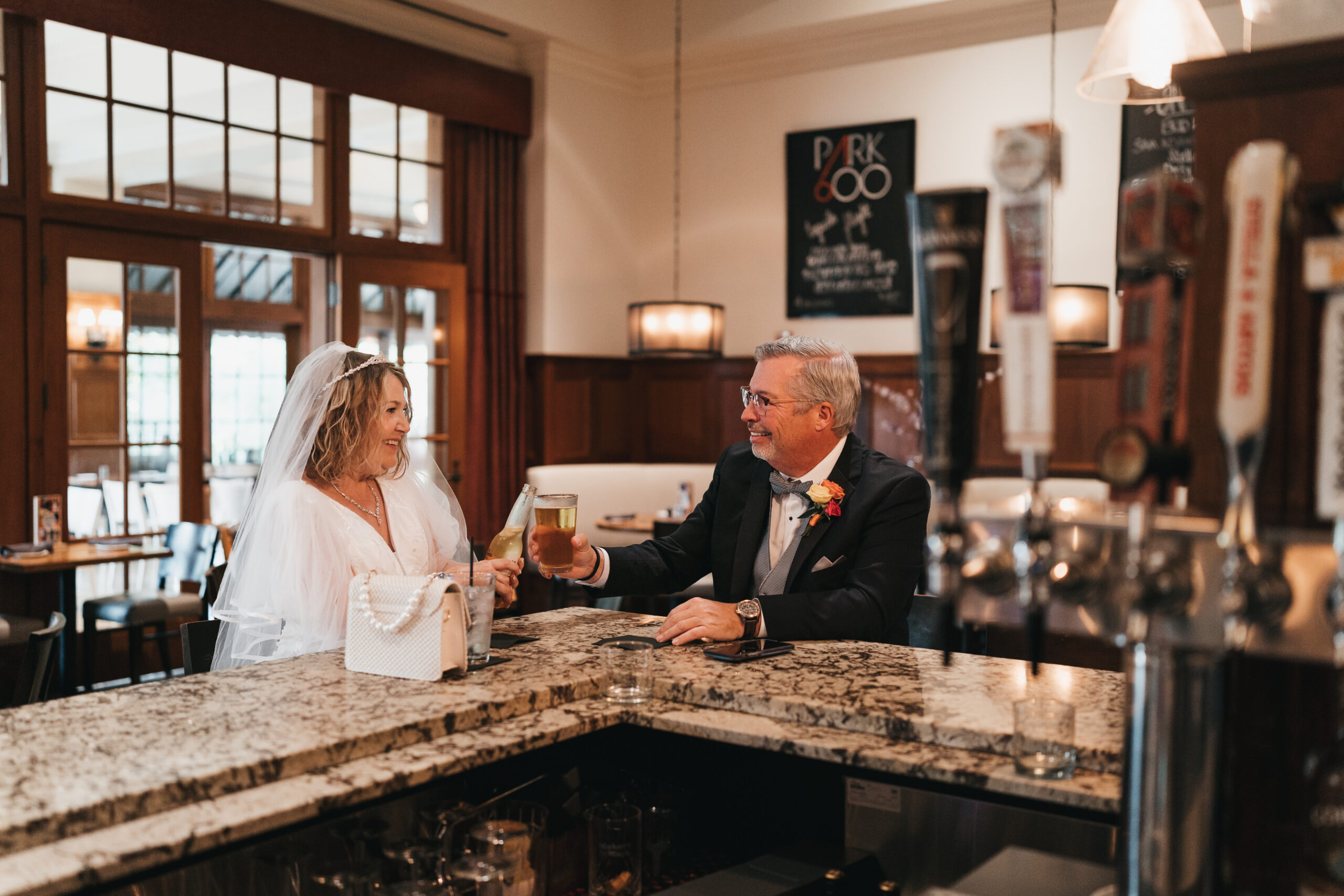 Bride and groom sharing a drink before their intimate Michigan wedding ceremony