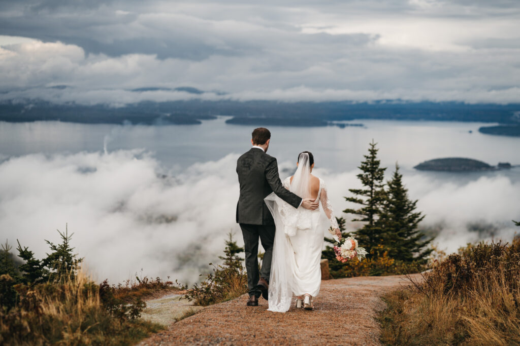 Bride and groom portraits in Acadia National Park with clouds rolling through the mountains
