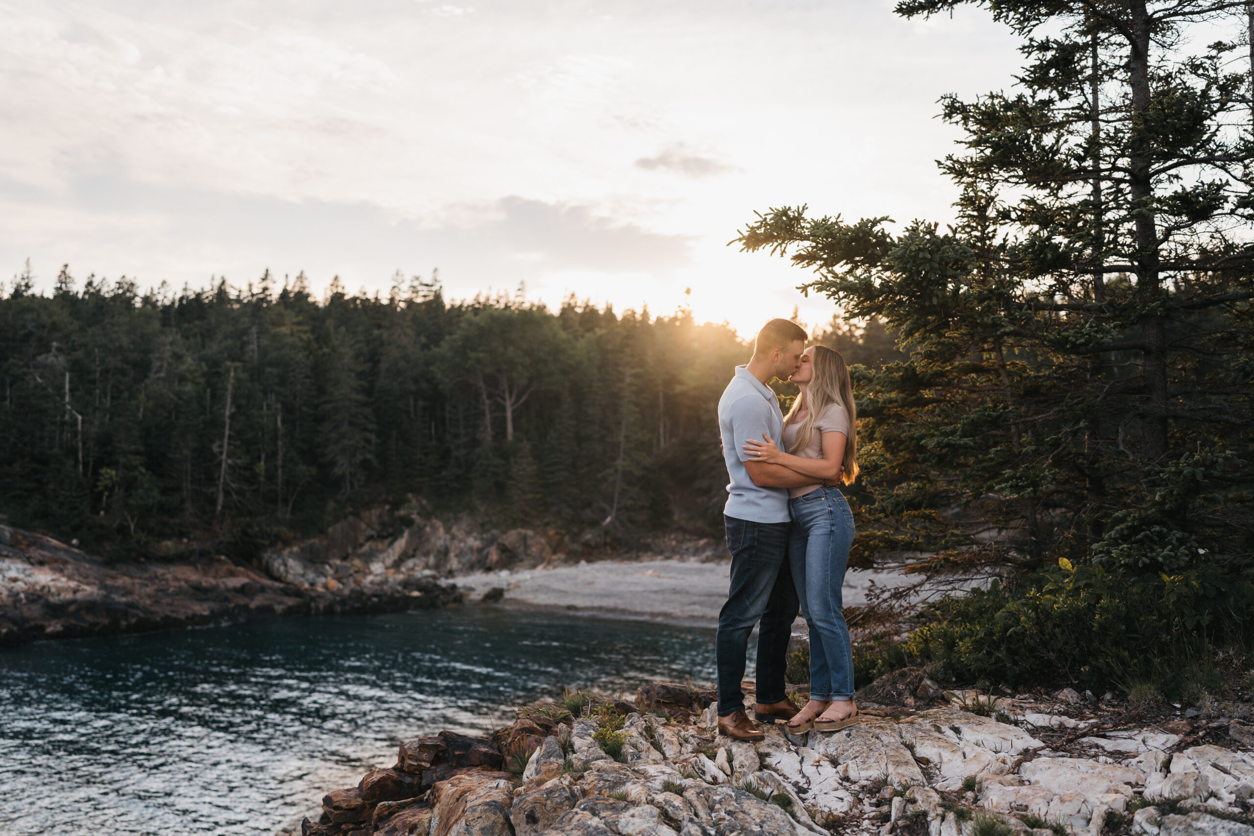 Newly engaged couple celebrating during sunset proposal in Acadia