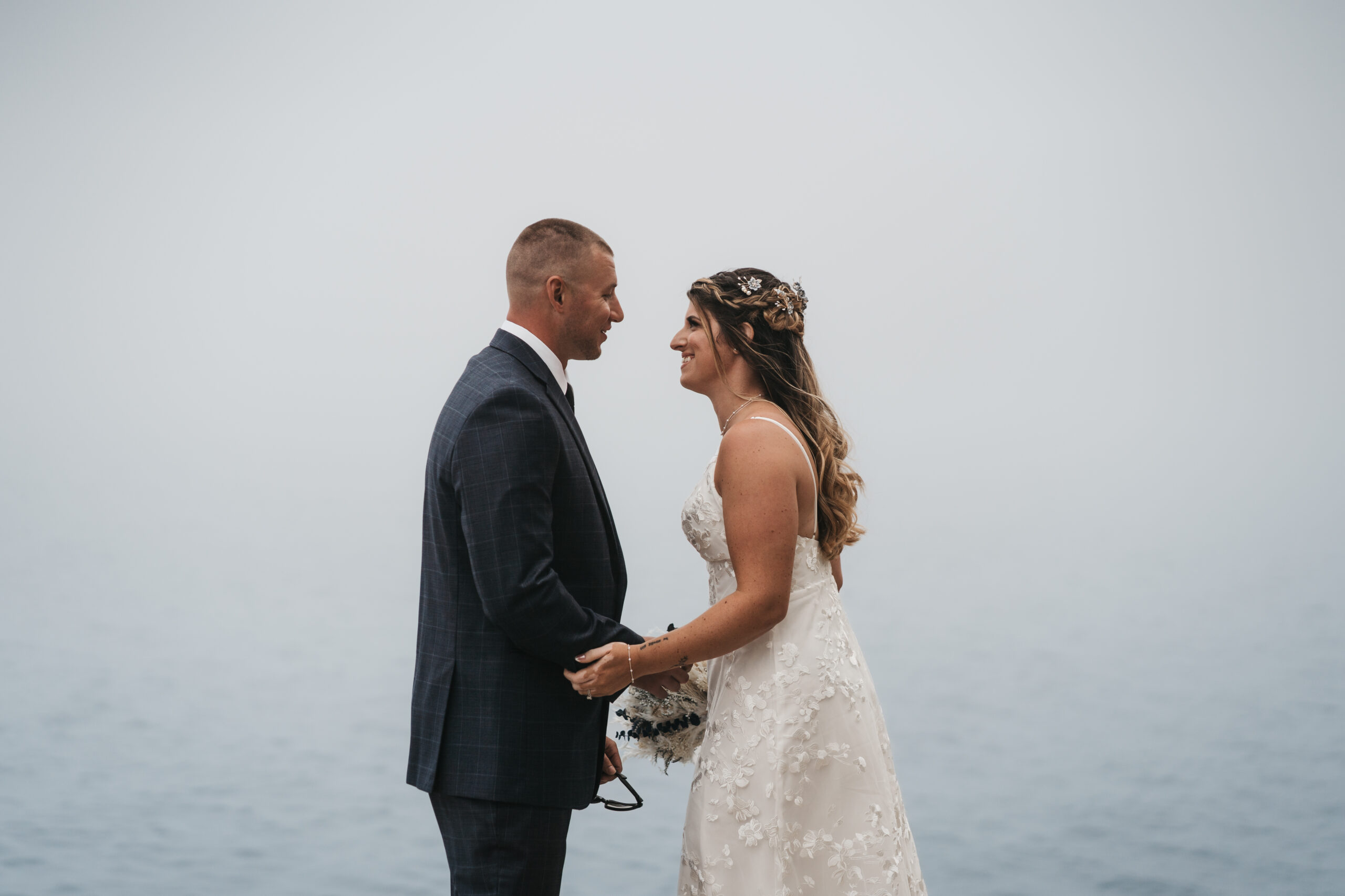 Emotional first look during a Maine Coastal elopement at Otter Point in Acadia National Park.