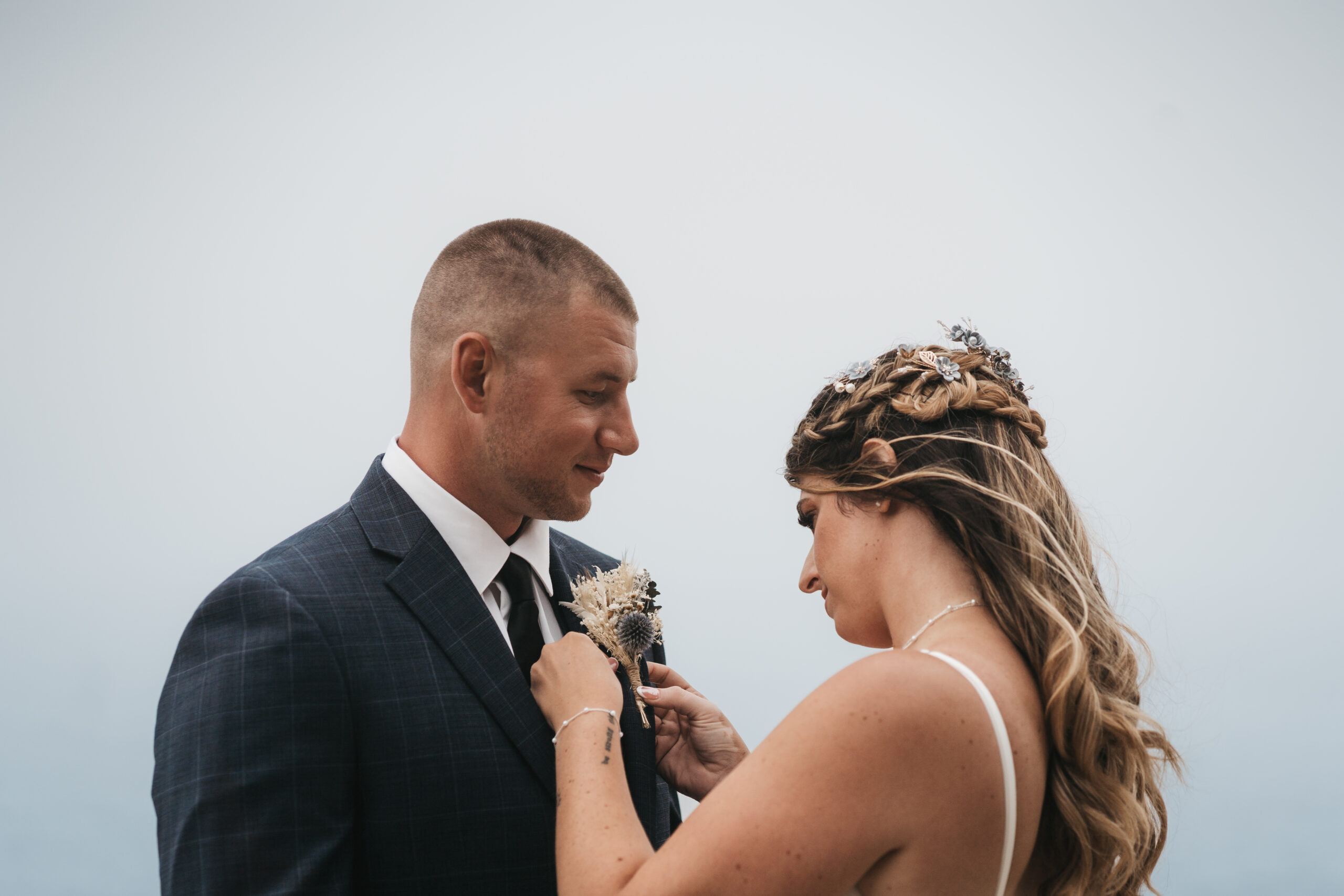 Emotional first look during a Maine Coastal elopement at Otter Point in Acadia National Park.