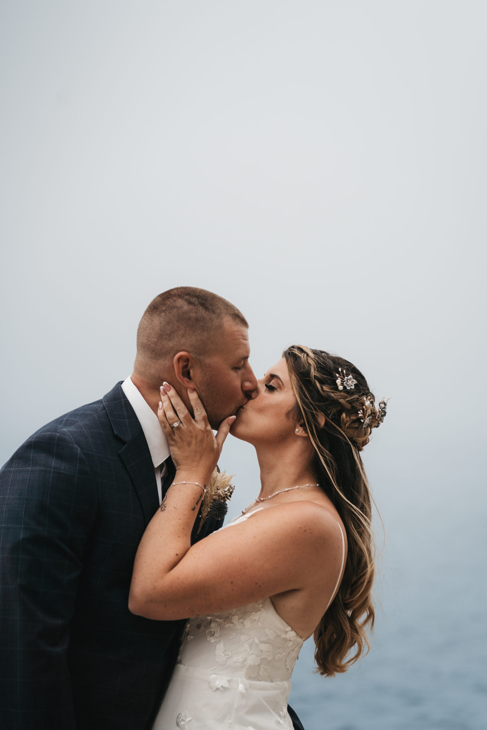 Couple embracing during a misty Maine Coastal elopement at Otter Point.