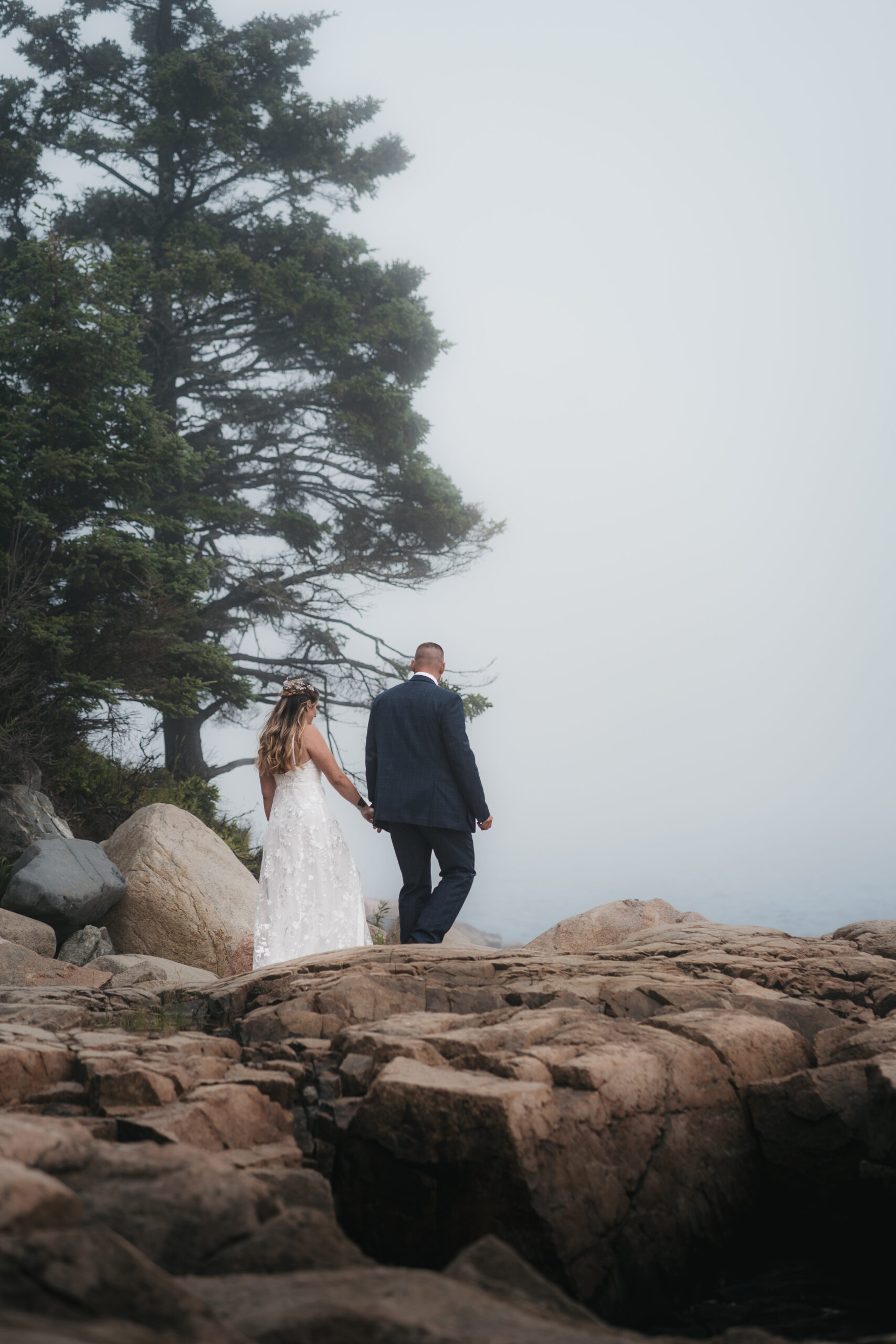 Couple walking towards their first look during an intimate Maine Coastal elopement.