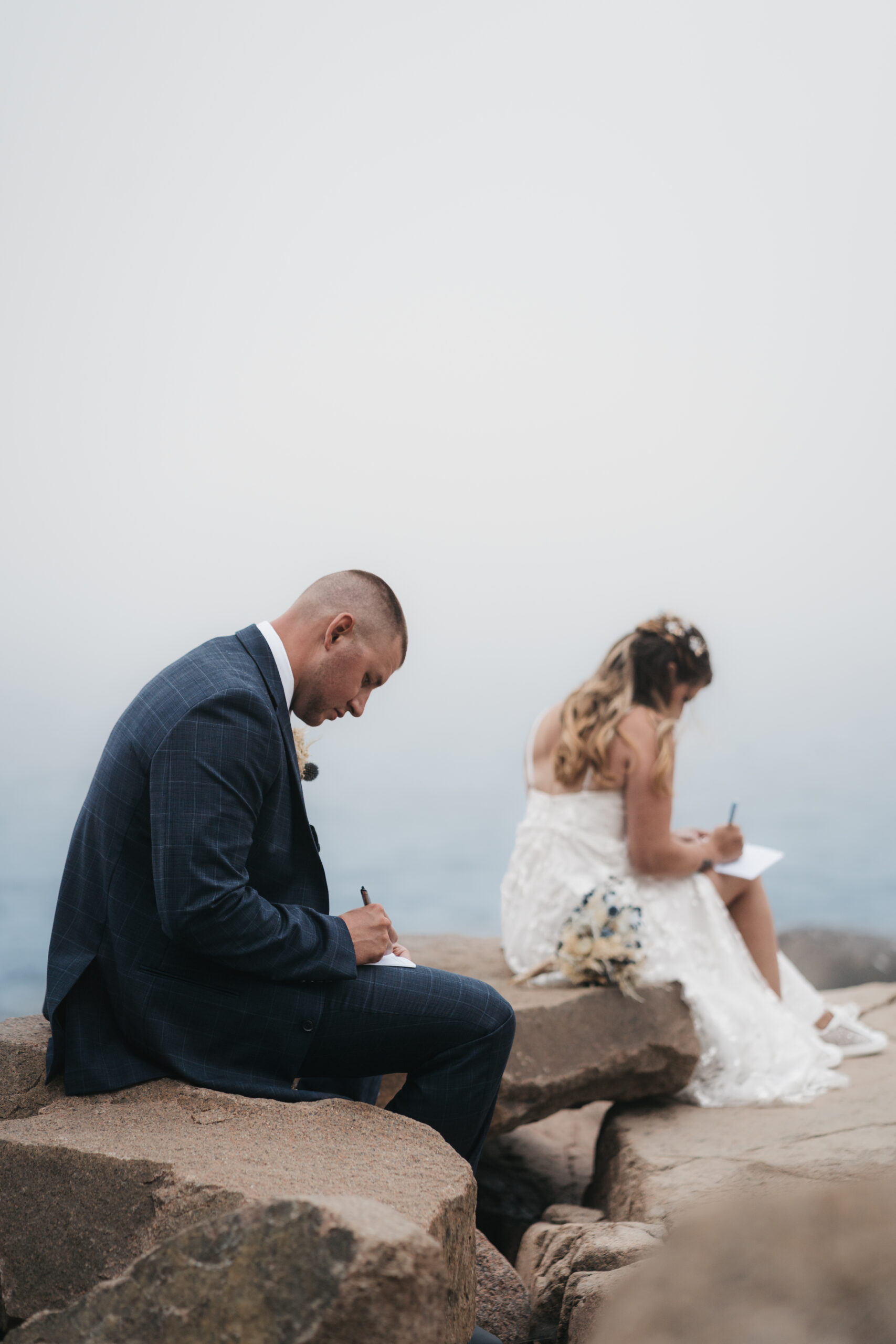 Bride and Groom writing their vows during their Maine Coastal elopement.
