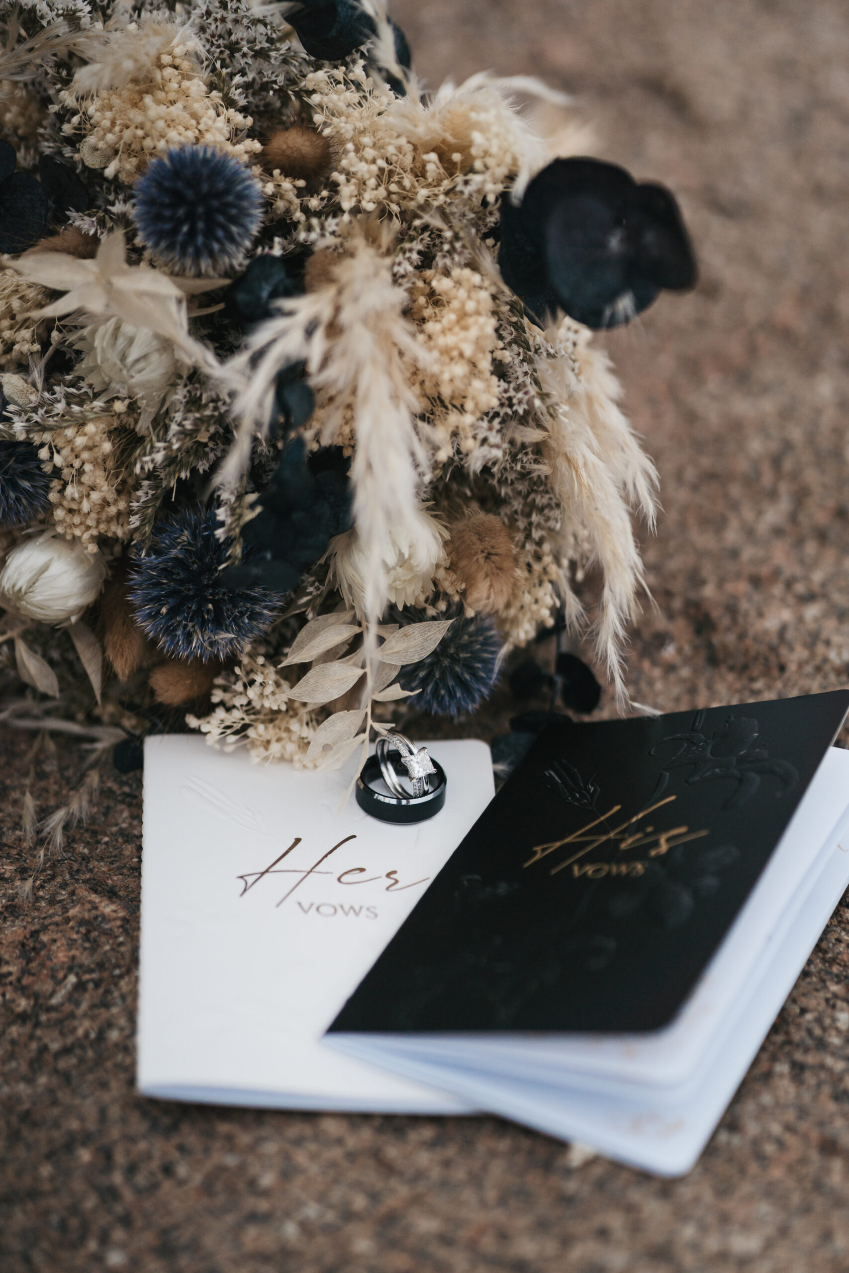 Detail shot of vow books and wedding rings at Otter Point.