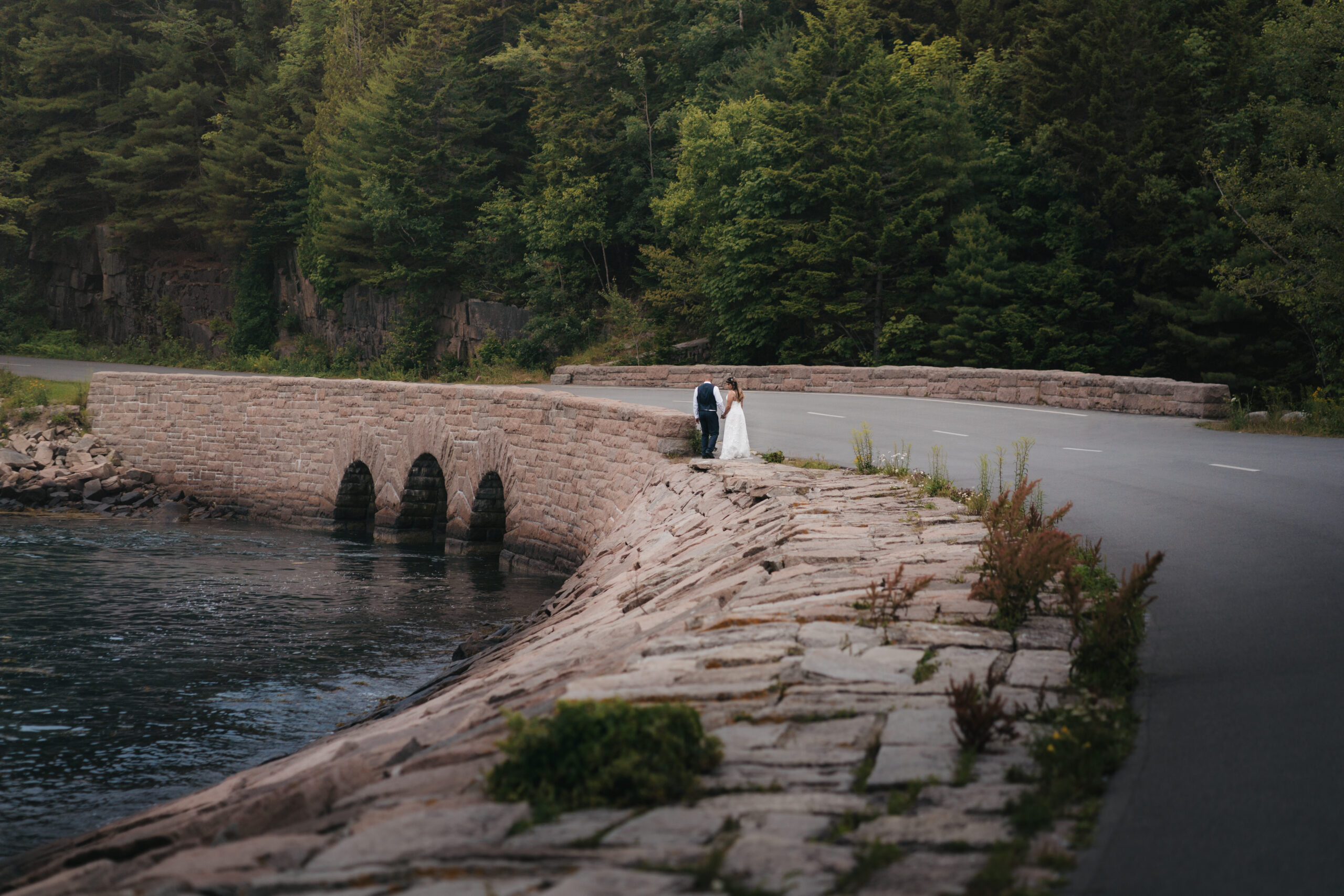 Bride and groom walking hand in hand at Otter Cove during their Maine Coastal elopement.