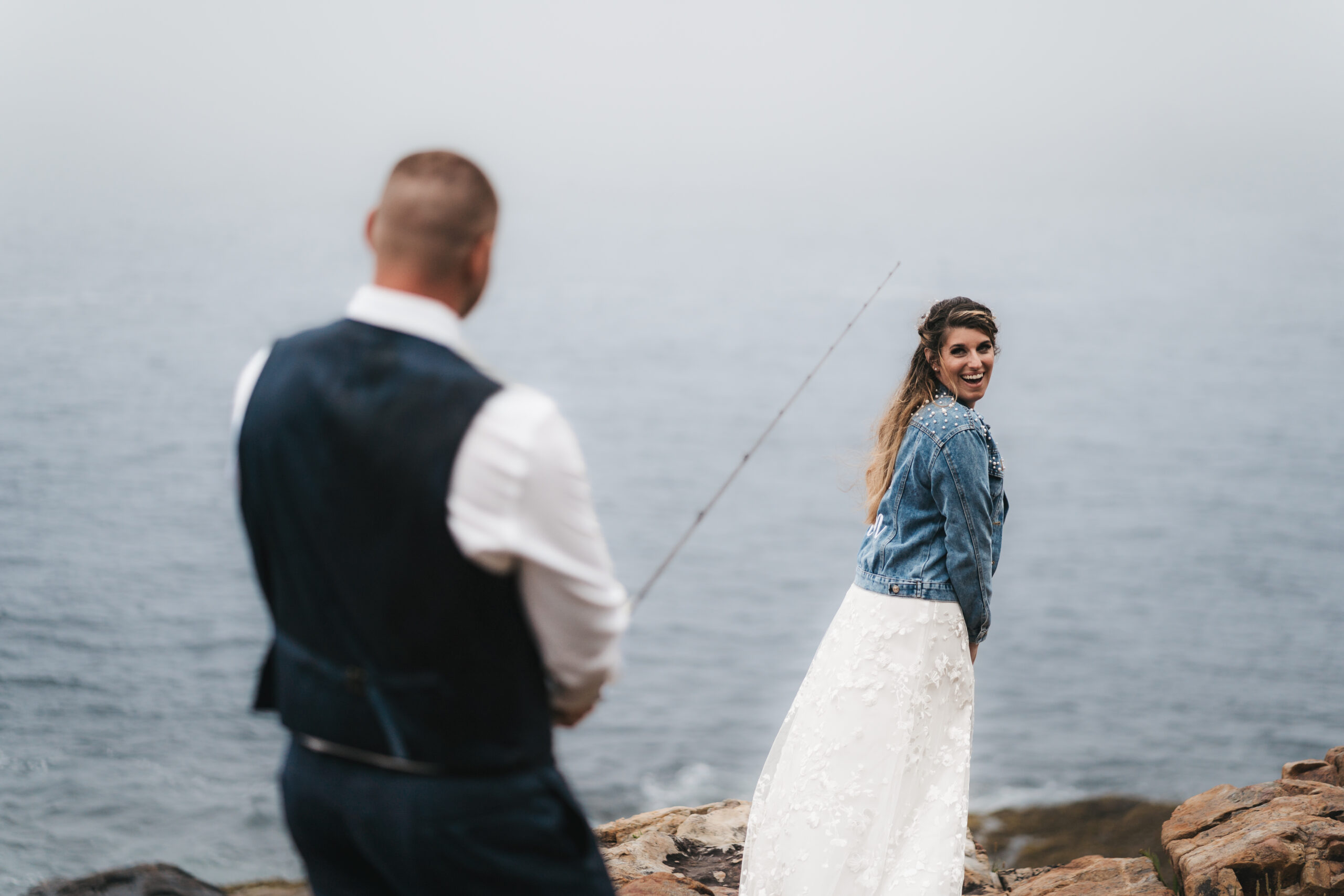 Fun wedding portraits with fishing rods at Acadia National Park.