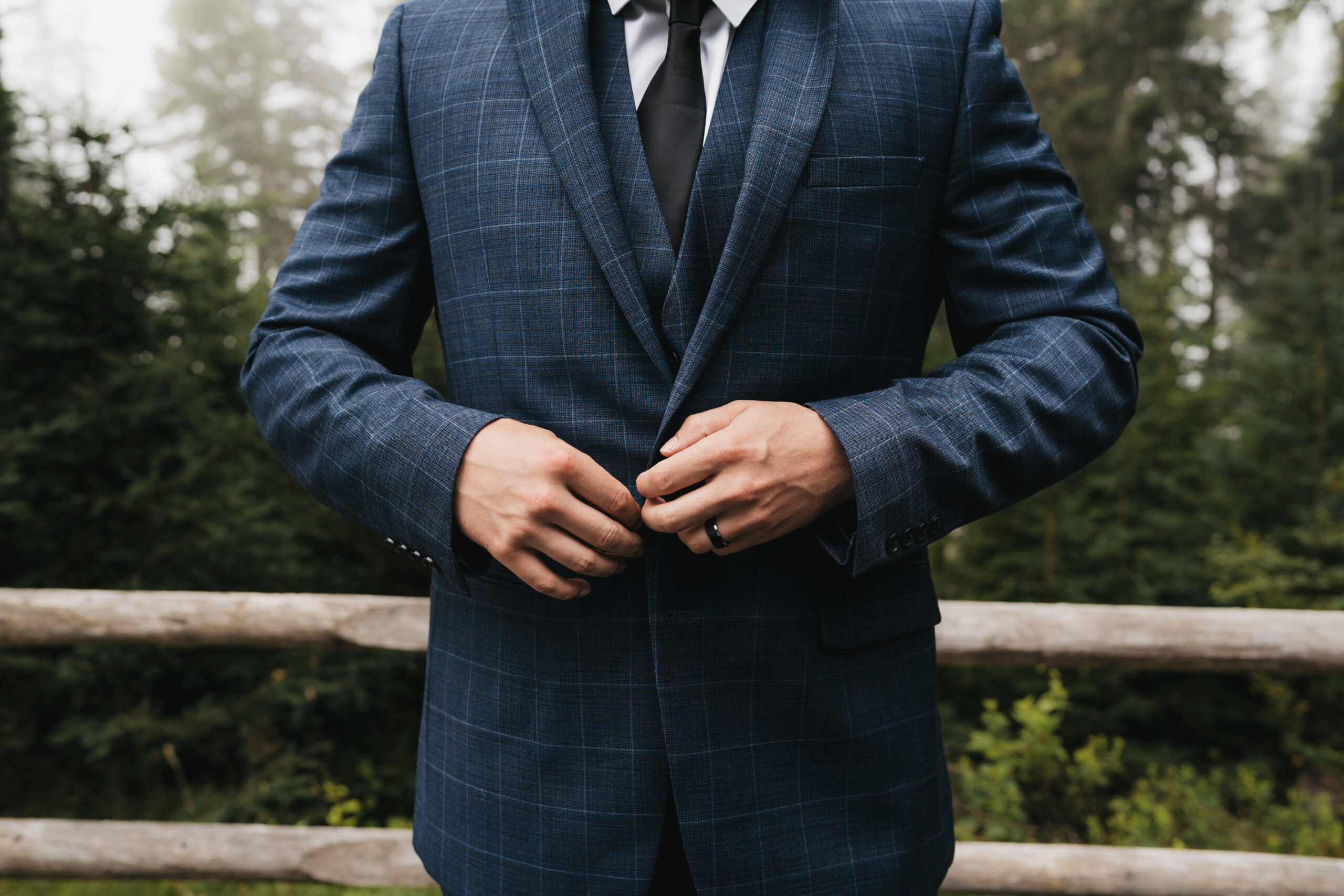 Groom adjusting his suit before an intimate Maine Coastal elopement in Acadia National Park.