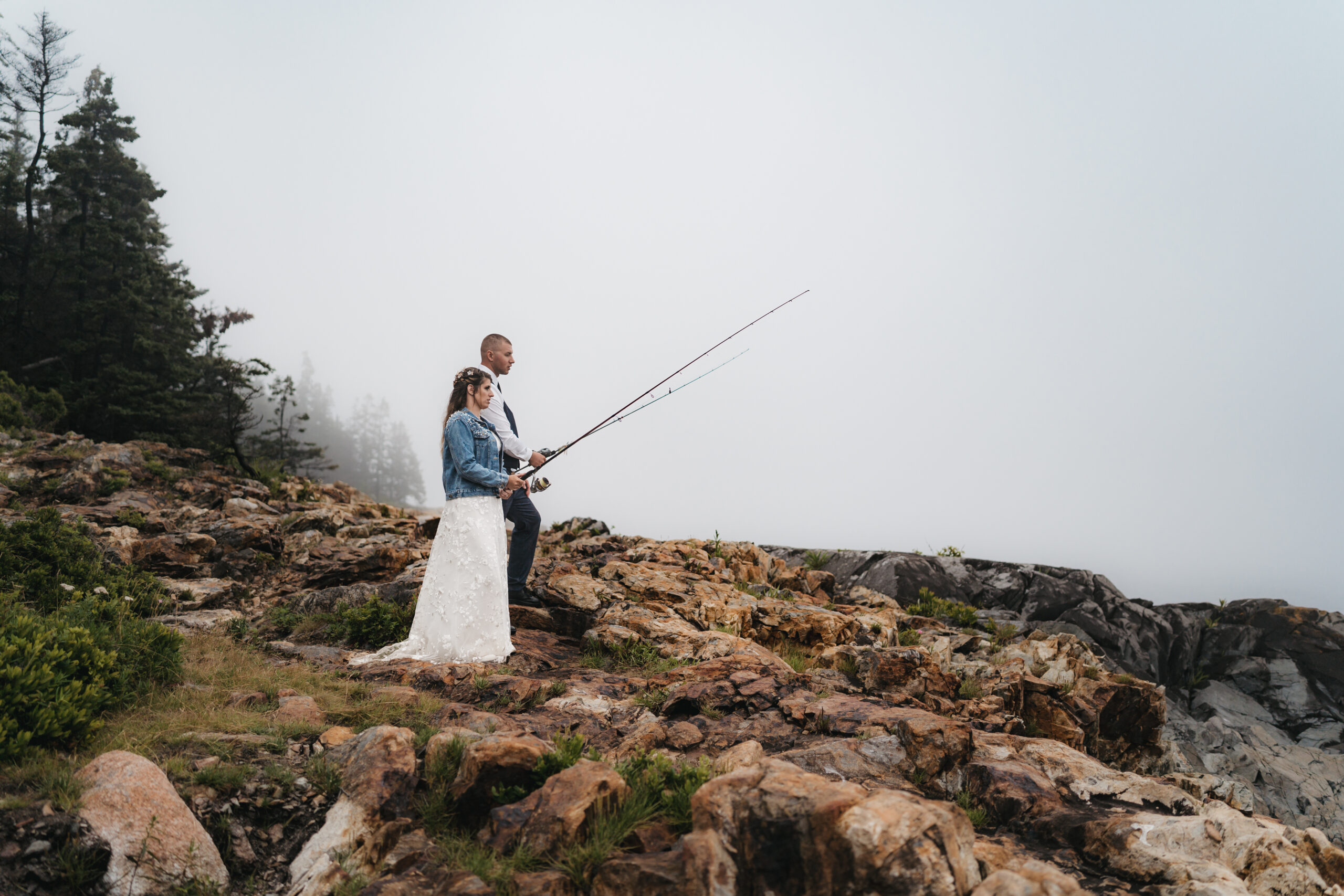 Fun wedding portraits with fishing rods at Acadia National Park.