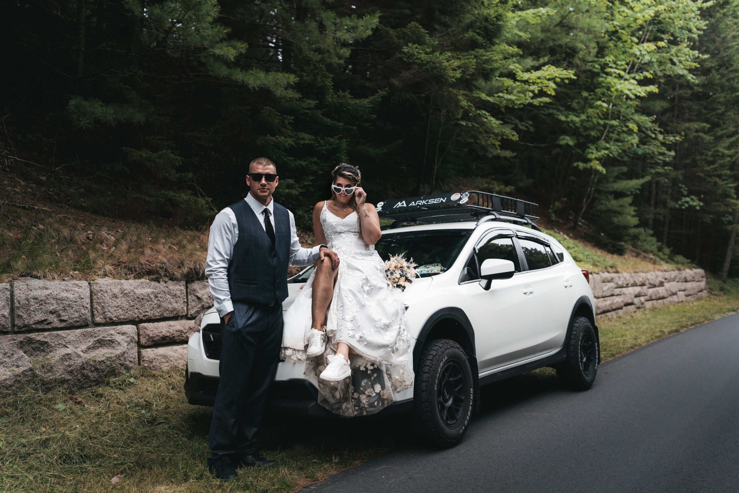Couple with custom Subaru Outback during their adventurous elopement in Acadia.