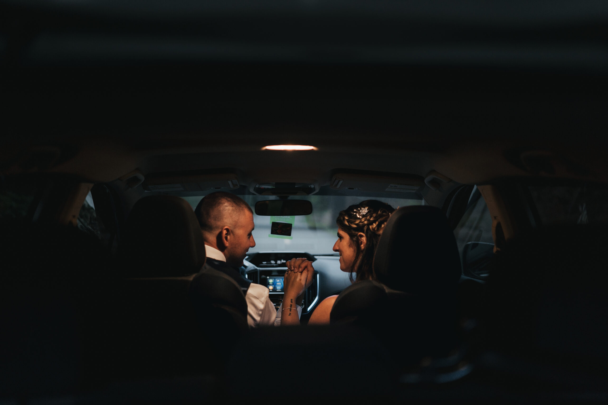 Romantic moment inside Subaru after a beautiful Maine Coastal elopement adventure.