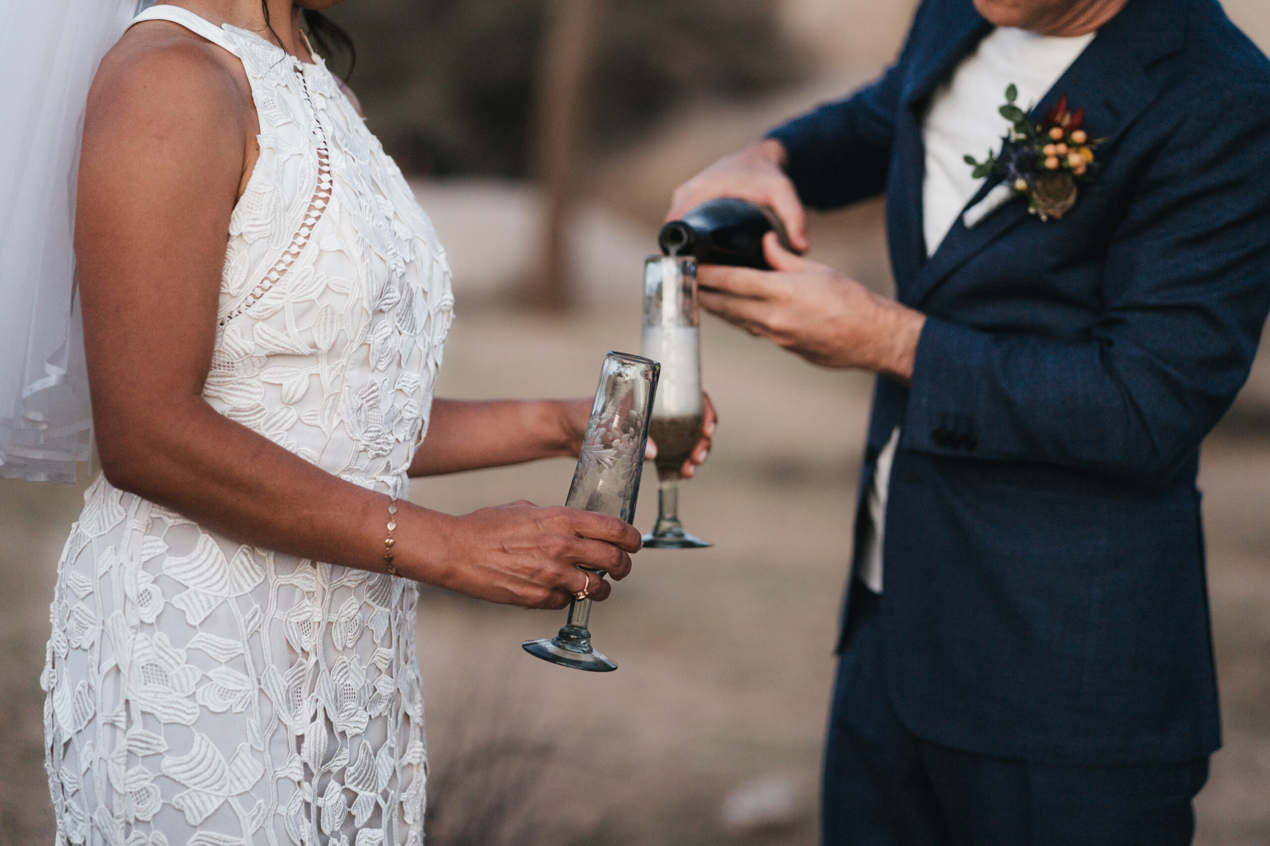 Couple celebrating with champagne after their Joshua Tree elopement.