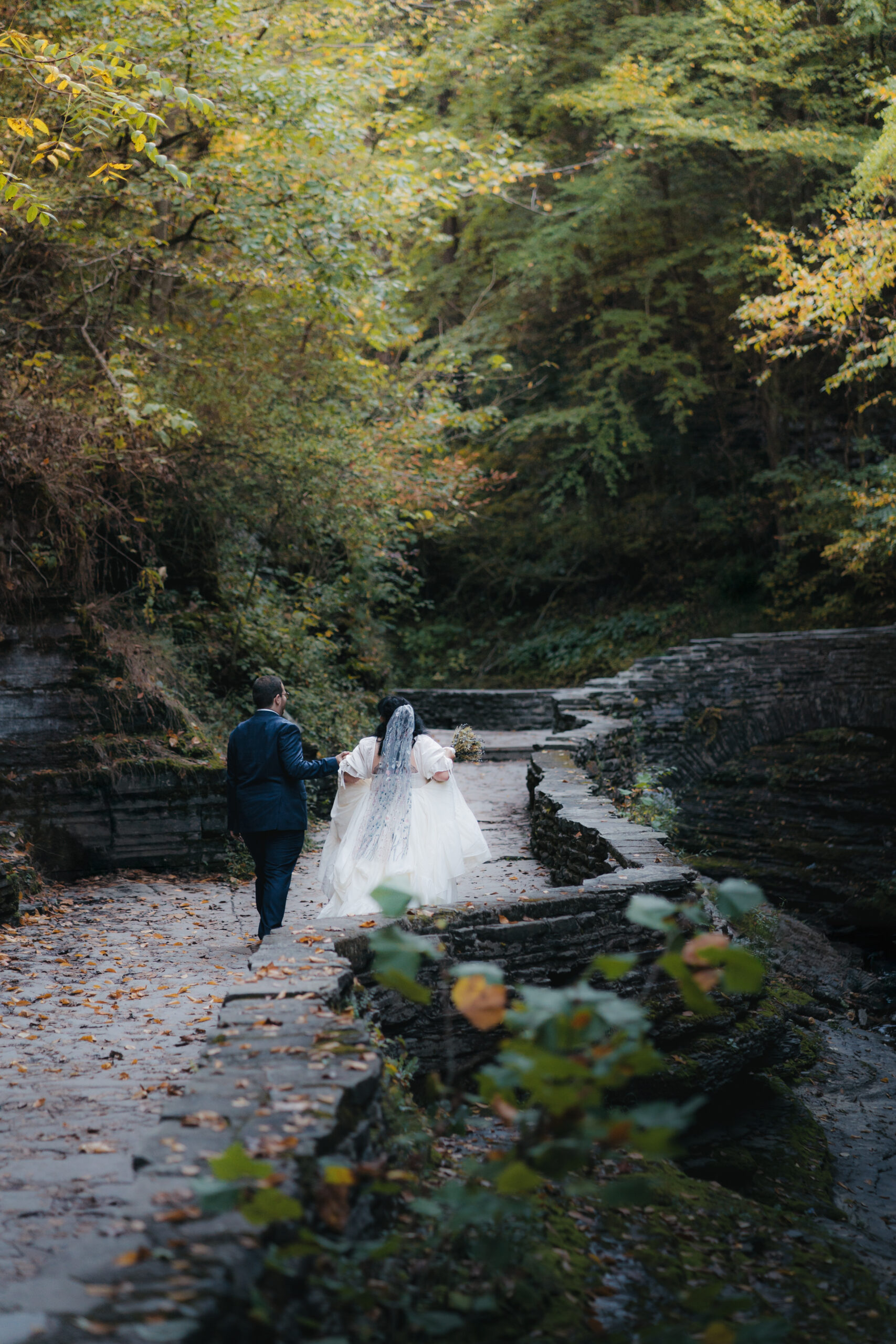 Couple exploring Watkins Glen State Park during their adventurous Watkins Glen elopement.
