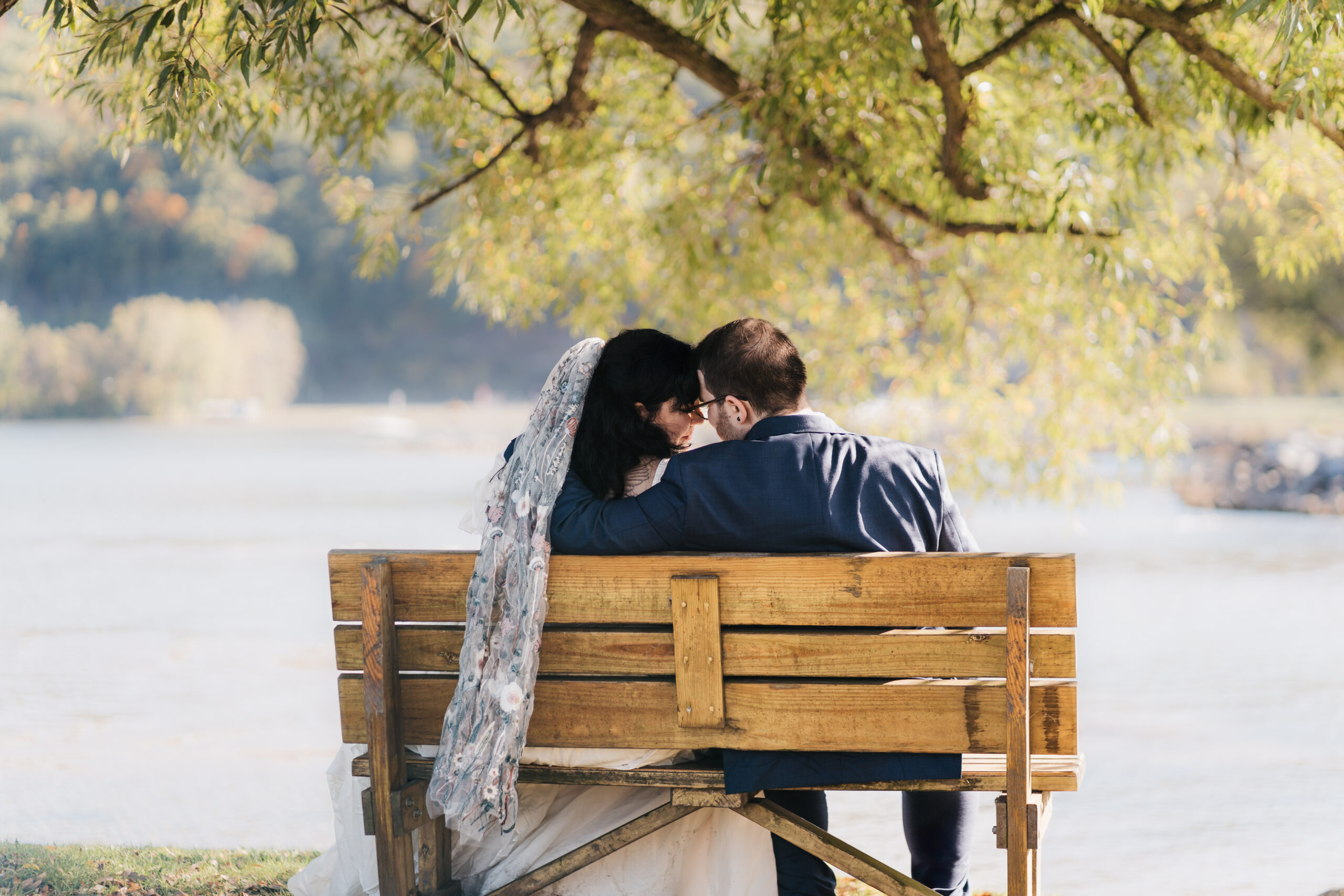 Bride and groom relaxing by the water during their Watkins Glen elopement.