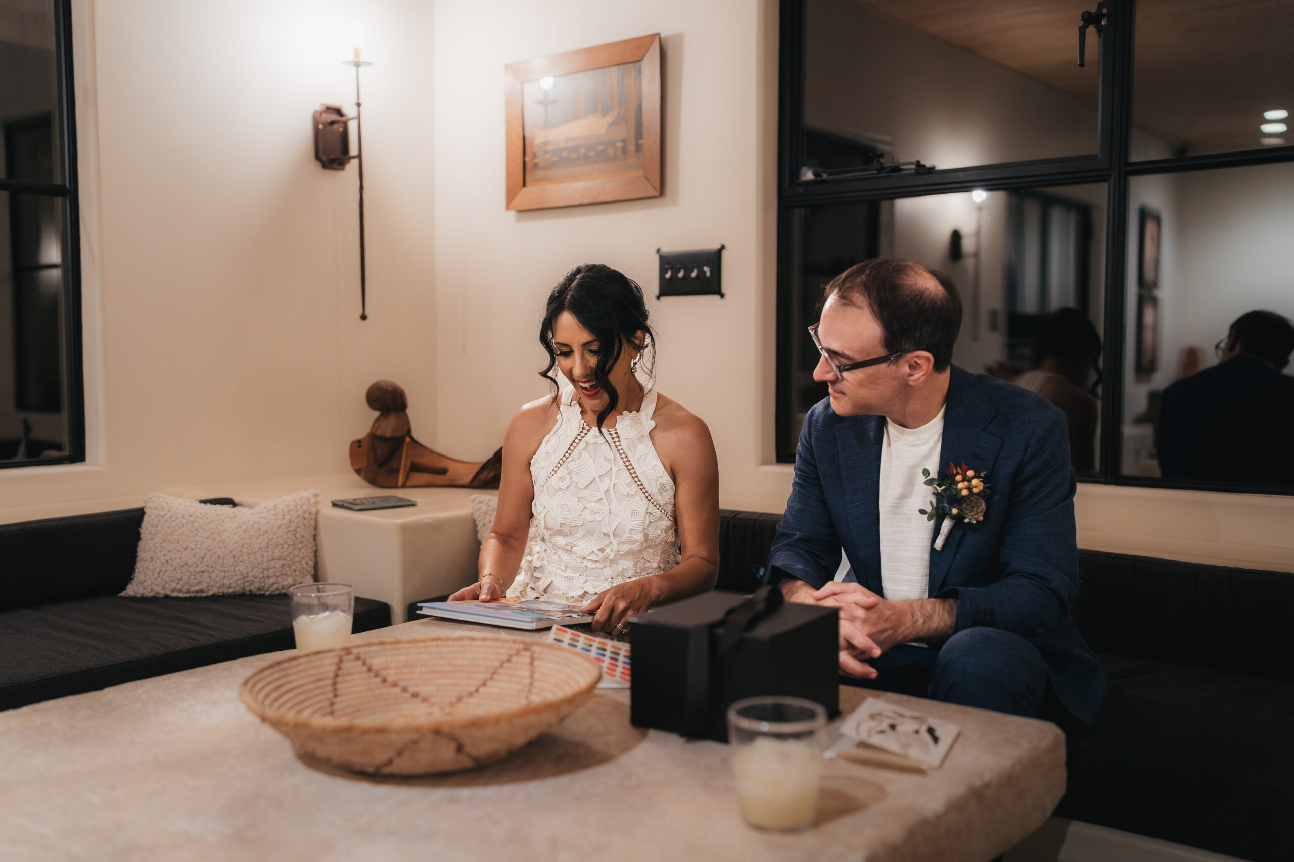 Bride opening a meaningful wedding gift after her Joshua Tree elopement.