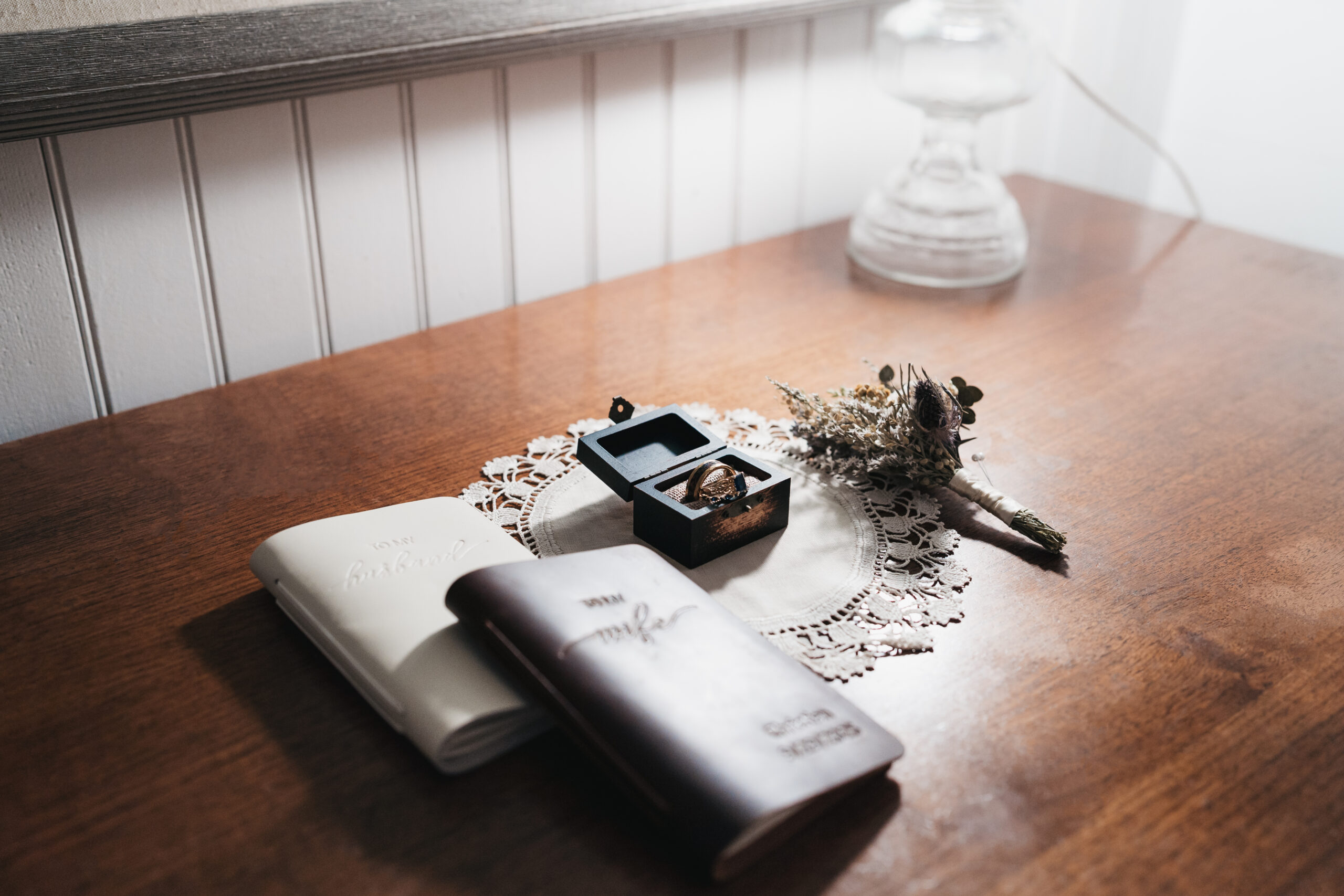 Vow books and wedding details during a Watkins Glen elopement.
