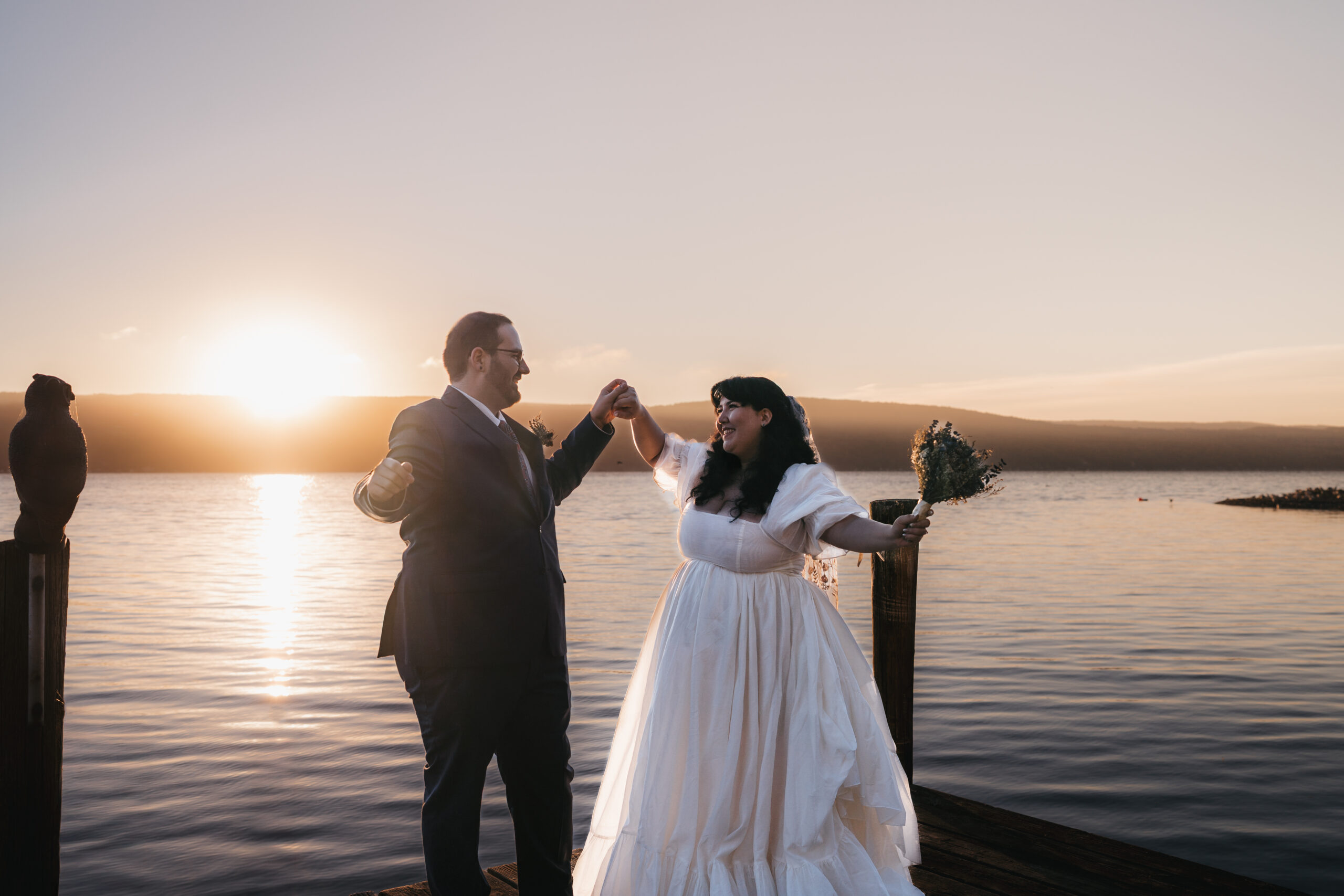 Newlyweds celebrating getting married on Seneca Lake during their sunrise elopement.