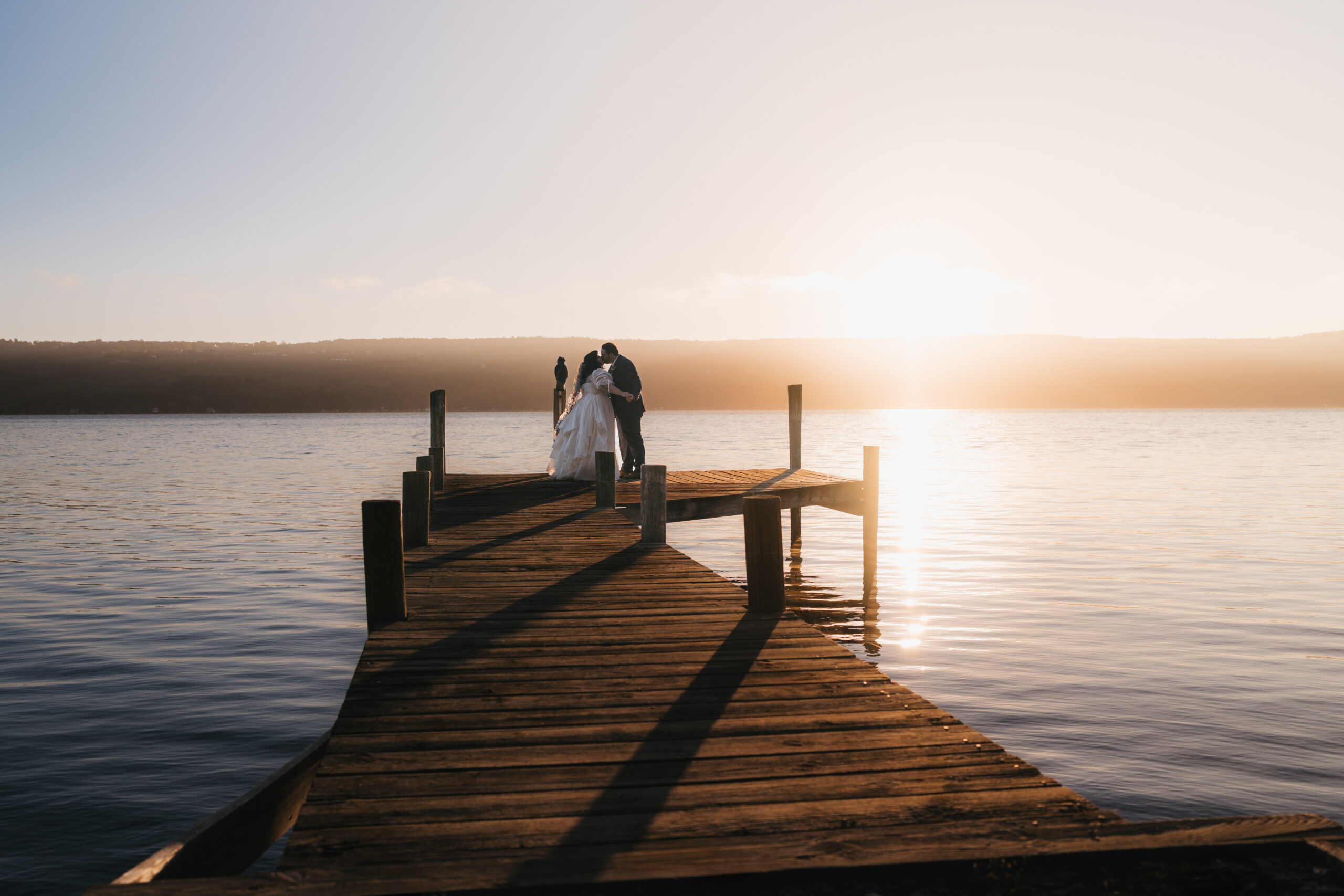 Couple exchanging vows on a dock during their intimate Watkins Glen elopement.