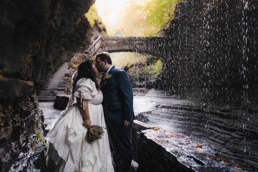 Newlyweds sharing a kiss at Watkins Glen State Park.