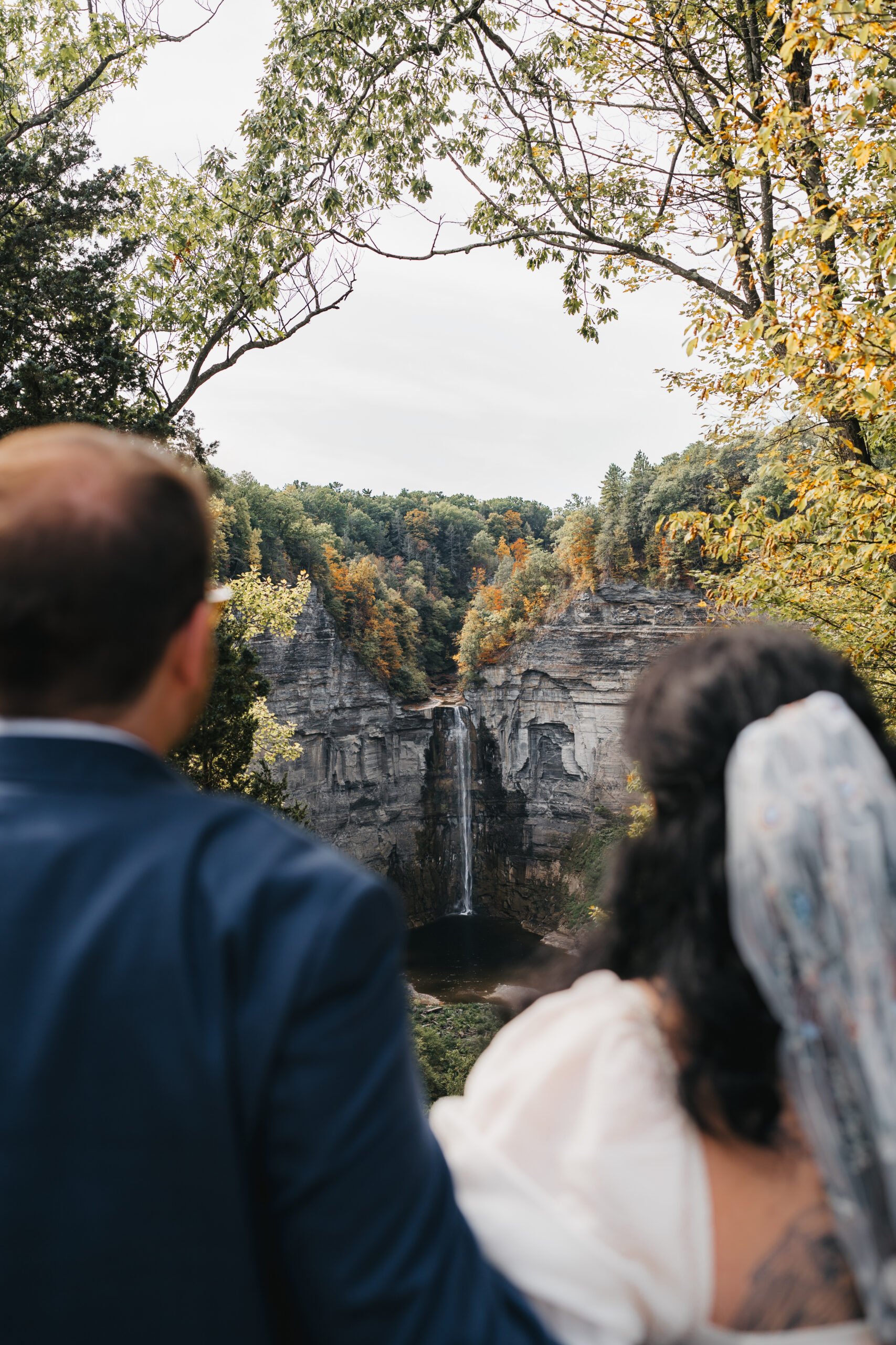 Couple overlooking Taughannock Falls during their adventurous Watkins Glen elopement.