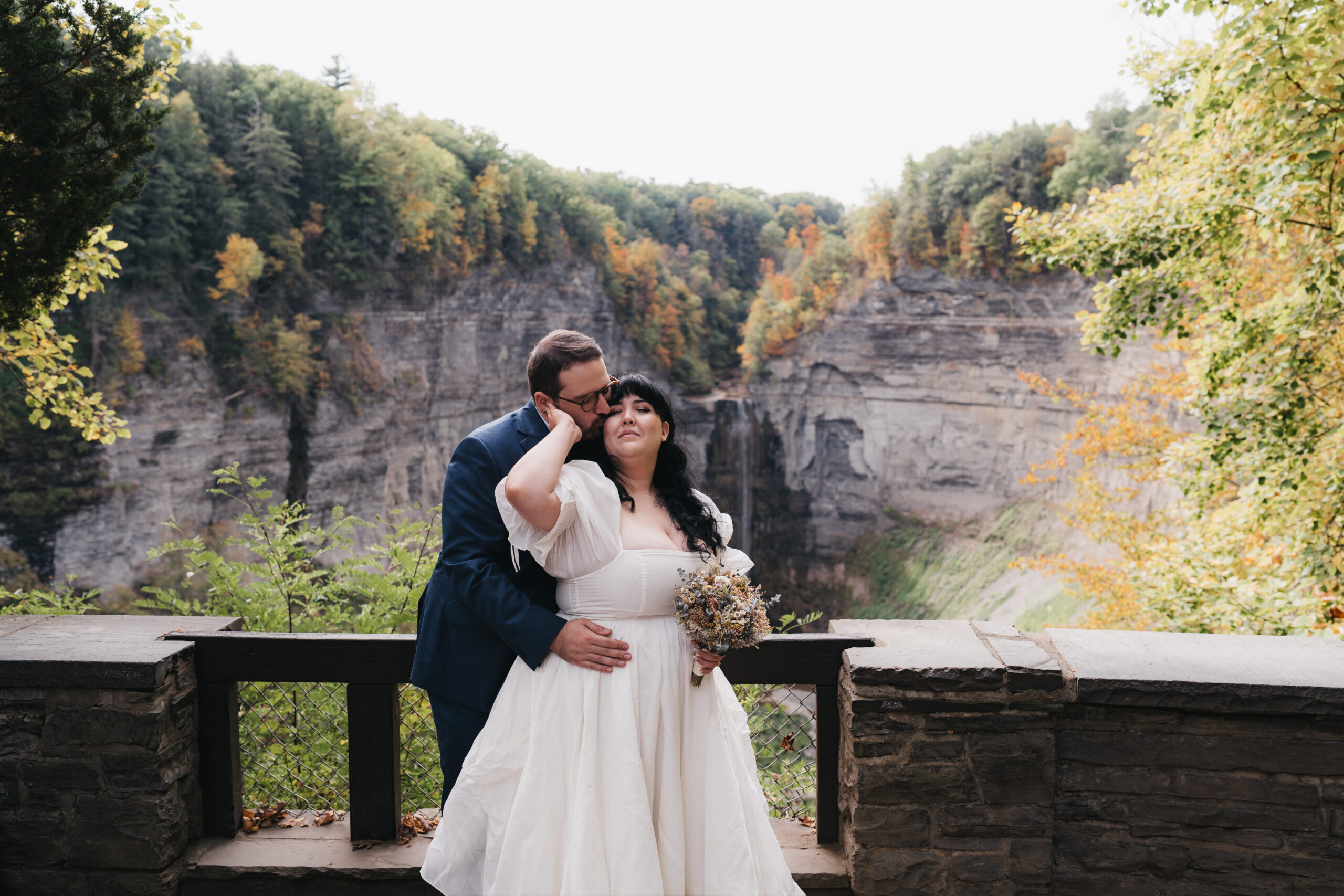 Bride and groom embracing each other at Taughannock Falls State Park.