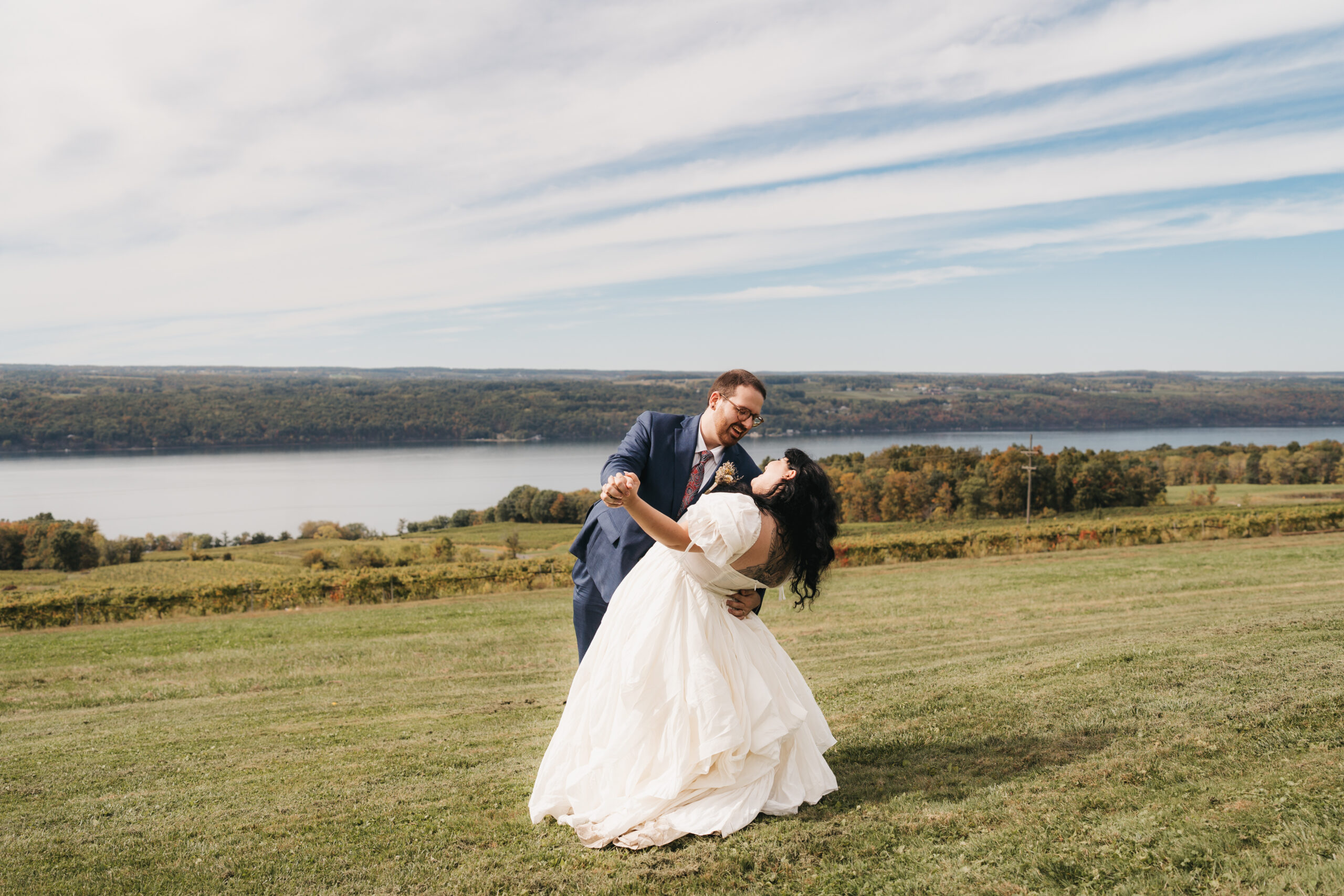 Groom dipping bride at vineyard during their romantic Watkins Glen elopement.