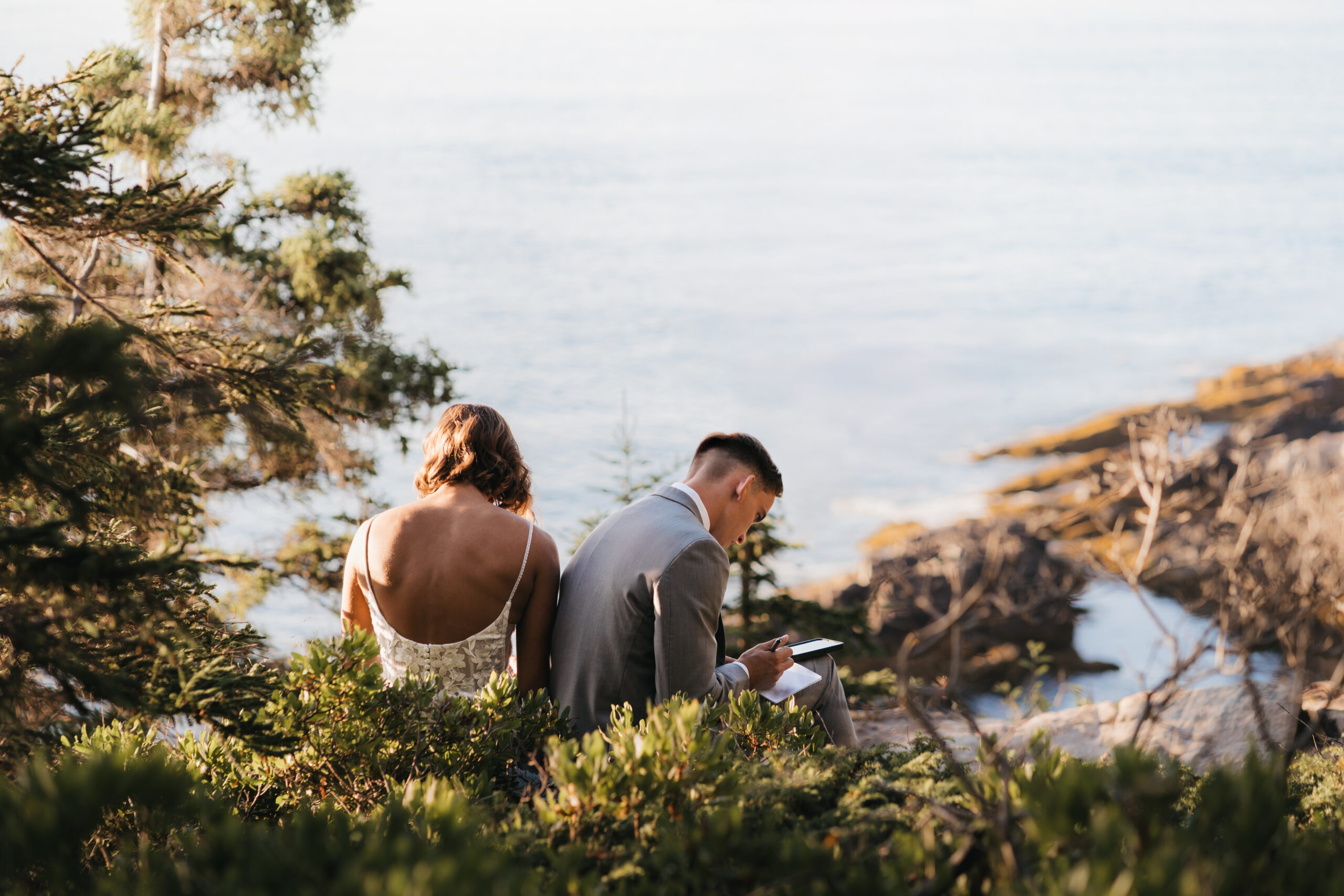 Couple writing personal vows during a Sunrise Acadia Elopement.