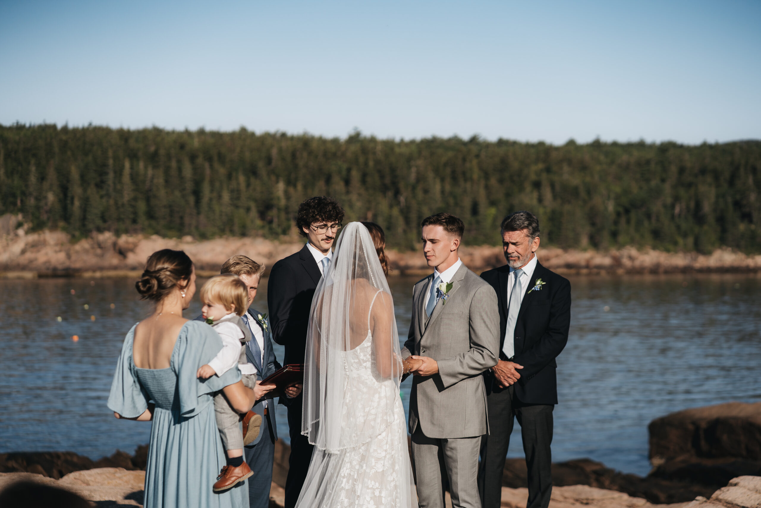 Newlyweds exchanging vows during their Acadia National Park ceremony.