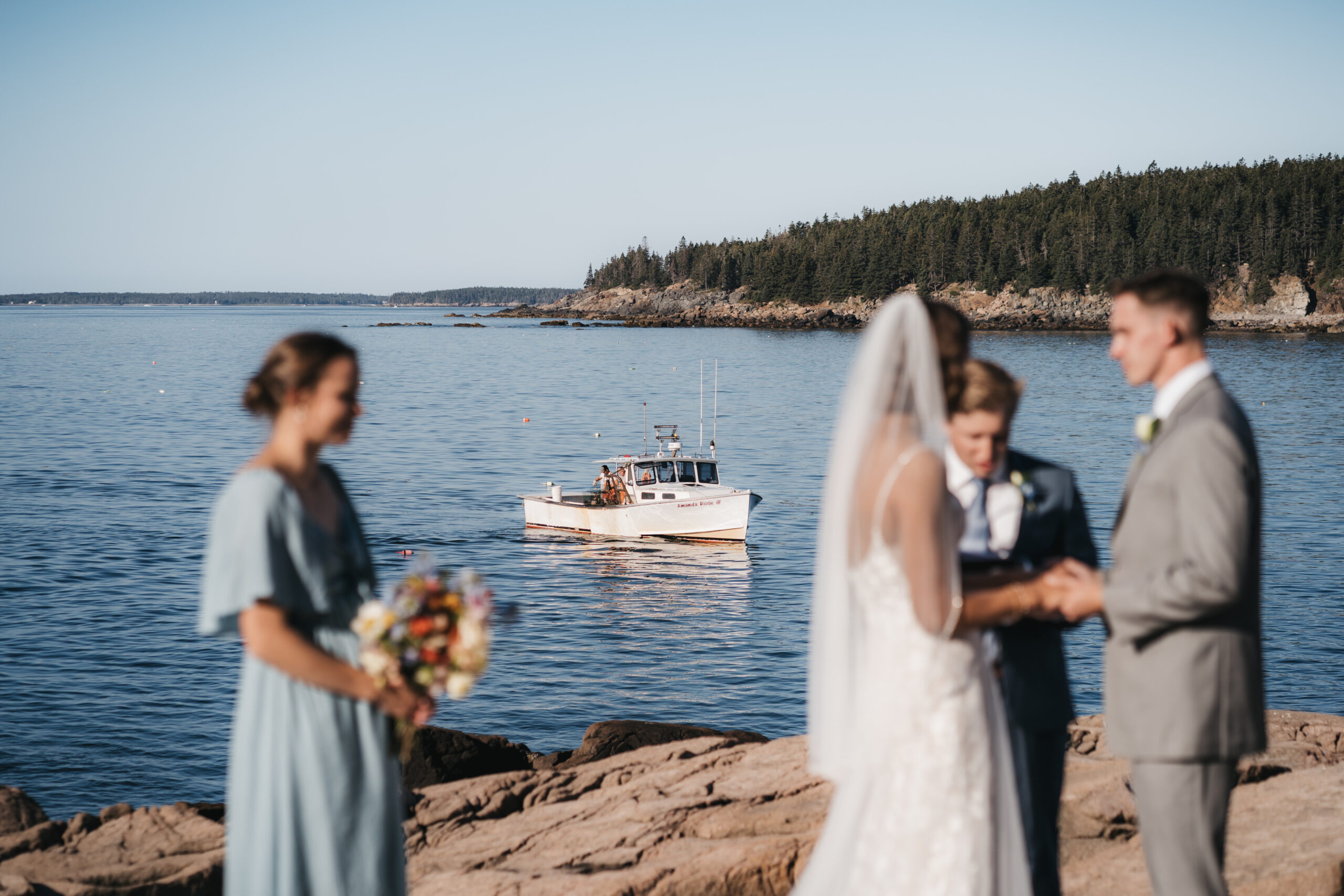 Lobster boats in the background of Acadia National Park ceremony.