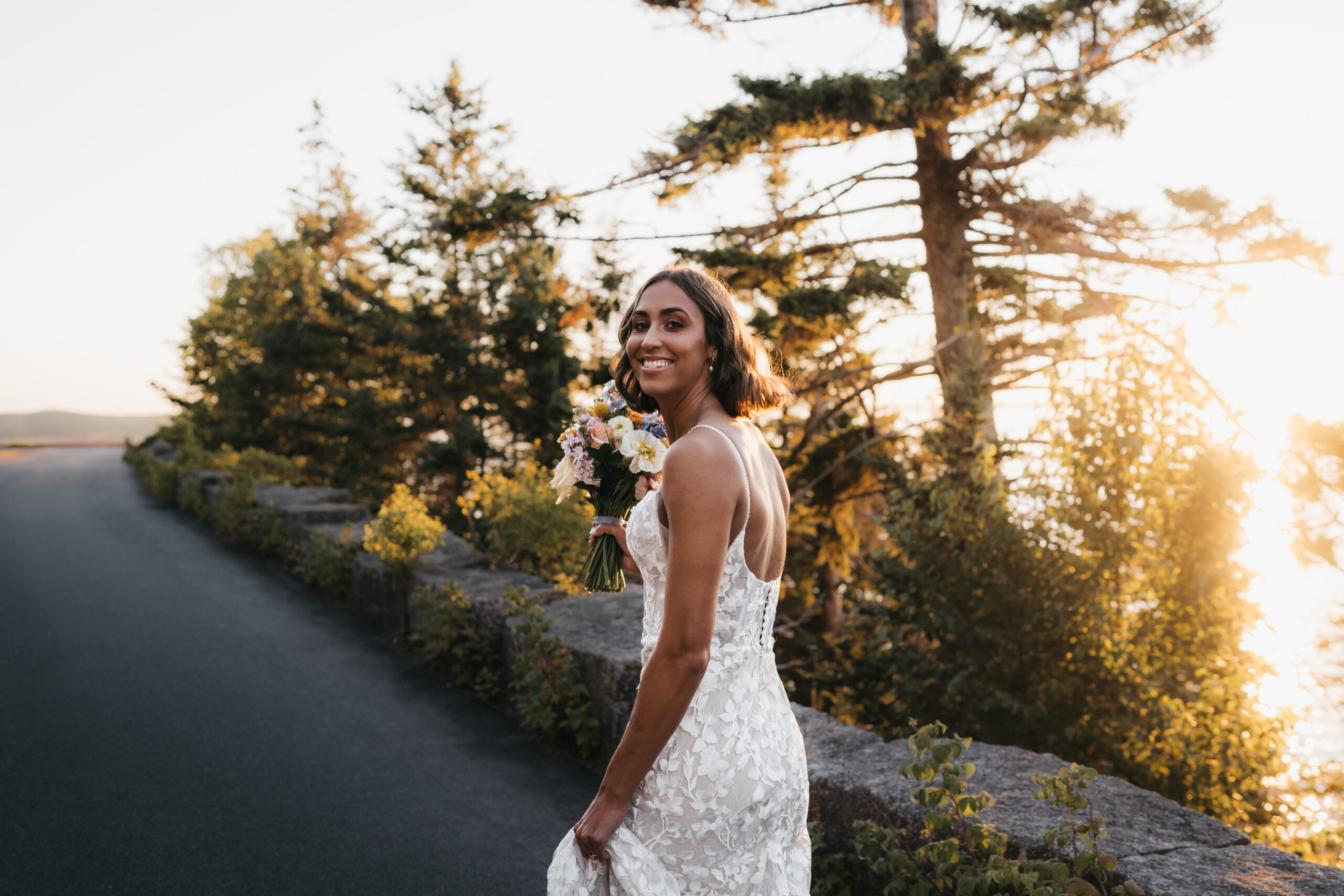 Bride walking toward groom at sunrise during an intimate Sunrise Acadia Elopement.