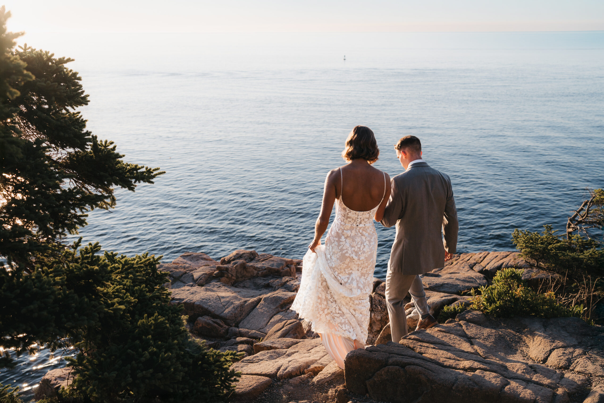Bride and groom overlooking the Atlantic Ocean while writing vows during a Sunrise Acadia Elopement.