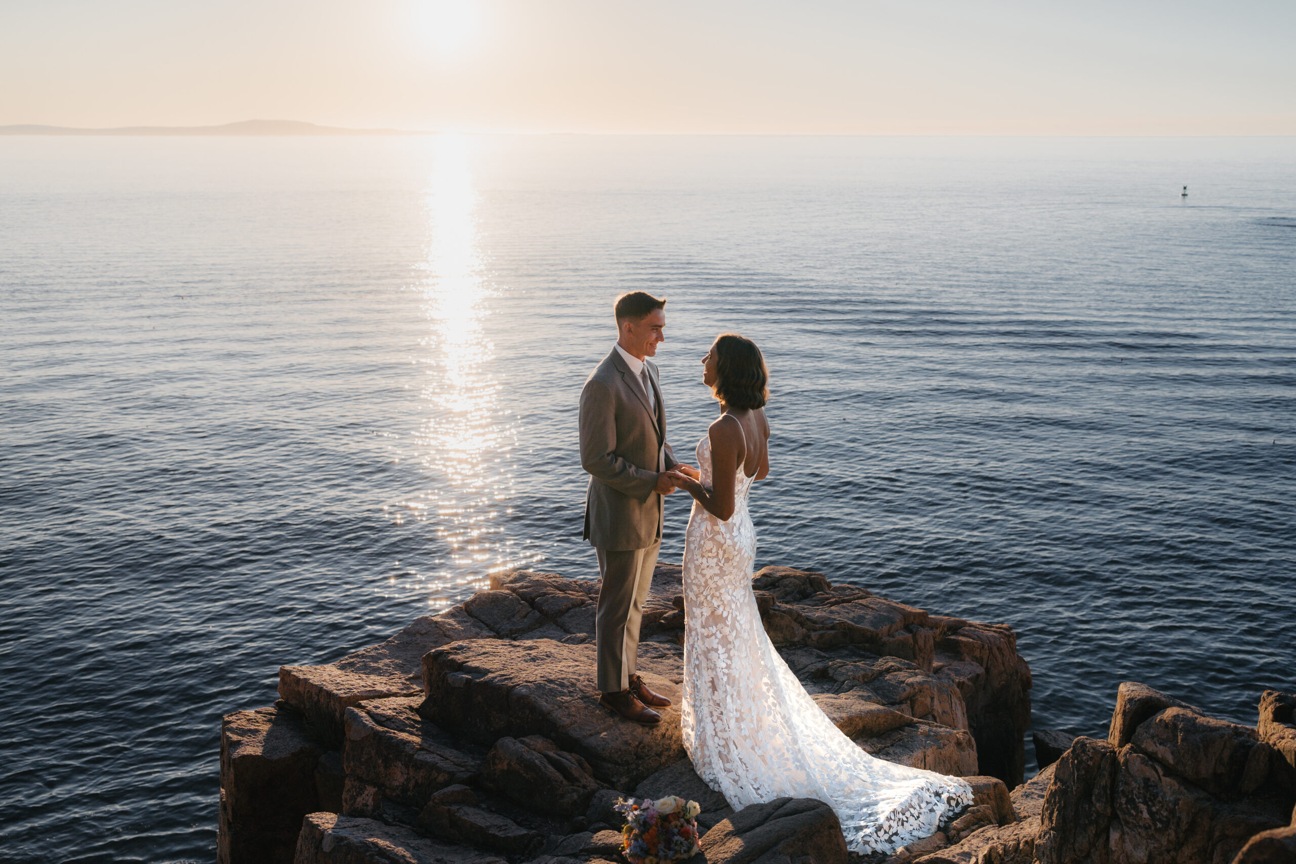 Couple sharing an emotional first look during a Sunrise Acadia Elopement at Otter Cliffs.