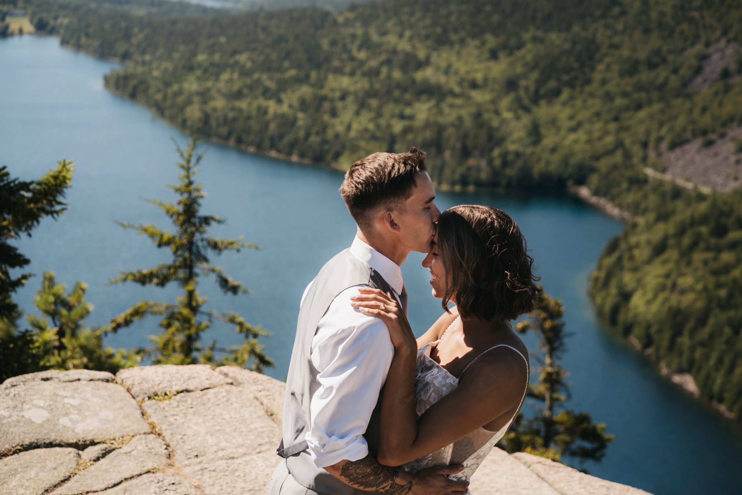 Groom sharing a kiss with his bride at North Bubble Overlook.